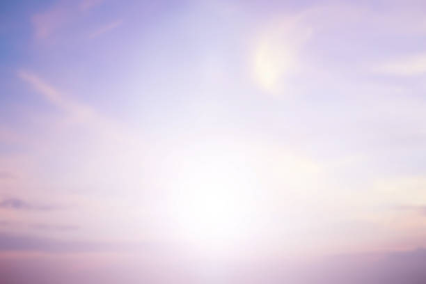 abstract blur beautiful sunset sky and soft cloud in pastel vintage tone background with flashing light filter concept