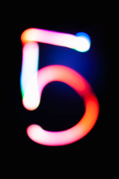istock Digit 5. Five. Glowing numbers on dark background. Abstract light painting at night. Creative artistic colorful bokeh. New Year. Use it for build you own design for book cover, poster or post card. 1031516128