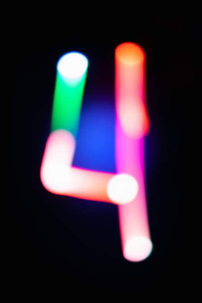 istock Digit 4. Four. Glowing numbers on dark background. Abstract light painting at night. Creative artistic colorful bokeh. New Year. Use it for build you own design for book cover, poster or post card. 1031516132