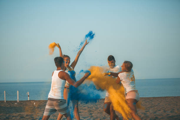 istock Cheerful people splashing colors 1031516188