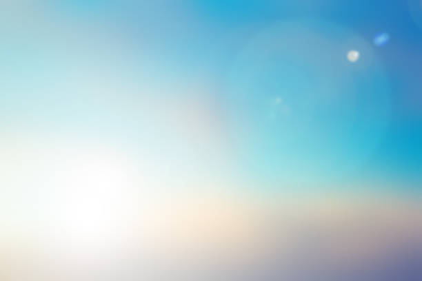 blurred beautiful natural morning sky in pastel tone color background with lens ray flare flash light. - lens flair imagens e fotografias de stock