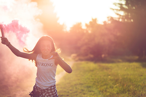 Angry girl in pink smoke.