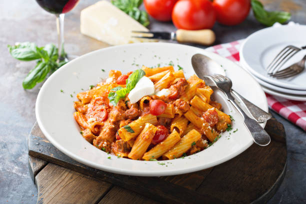 Rigatoni bolognese with fresh mozarella and basil Rigatoni bolognese with fresh mozarella and basil in a big plate mozzarella photos stock pictures, royalty-free photos & images