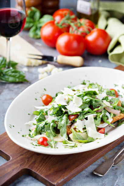 chicken parmesan topped with arugula - parmesan cheese chicken veal salad imagens e fotografias de stock