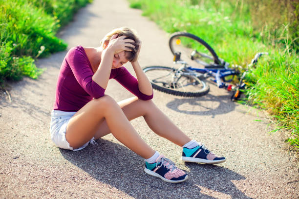 Woman with head injury after biking on bicycle. Sport, healthcare and people concept Woman with short hair with head injury after biking on bicycle. Sport, healthcare and people concept concussion stock pictures, royalty-free photos & images
