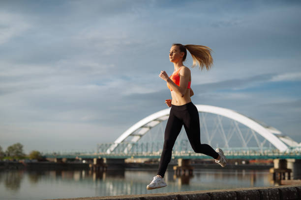 istock Young girl exercising and jogging on sunny day 1031532000