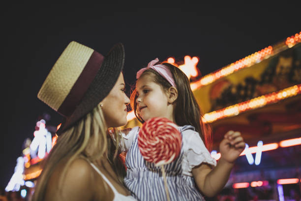 istock Smiling mother and daughter visiting a amusement park 1031535522