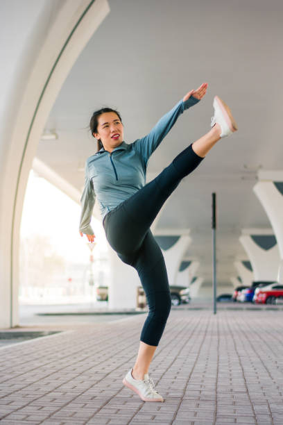 istock Girl stretching before workout on the parking lot 1031535826