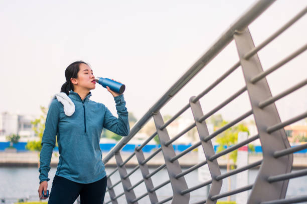 istock Female hydrating after workout outdoors 1031538146