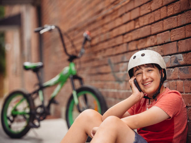 istock Teen biker using smart phone 1031542304