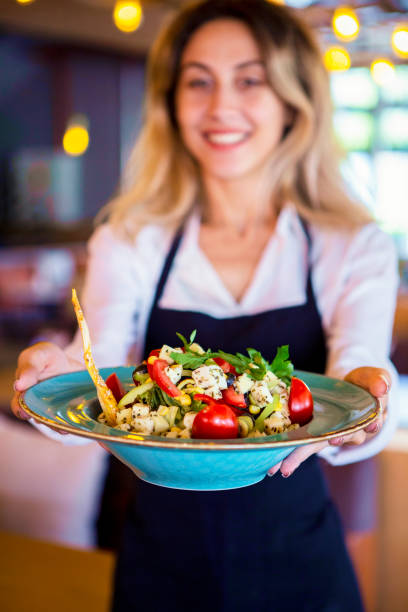 istock Waitress in restaurant serving food to customers 1031544738