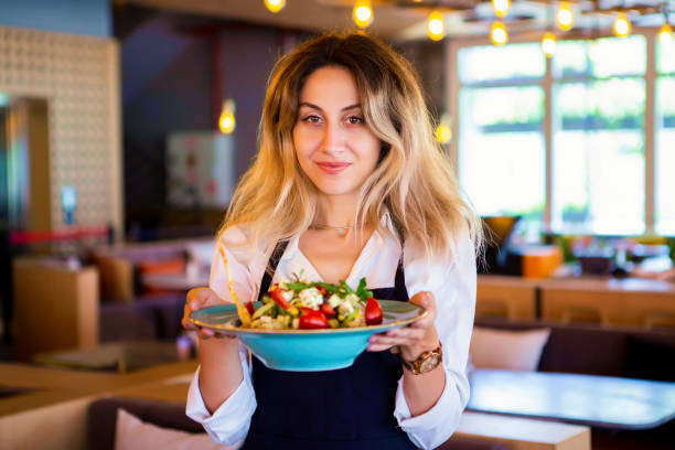 istock Waitress in restaurant serving food to customers 1031544840