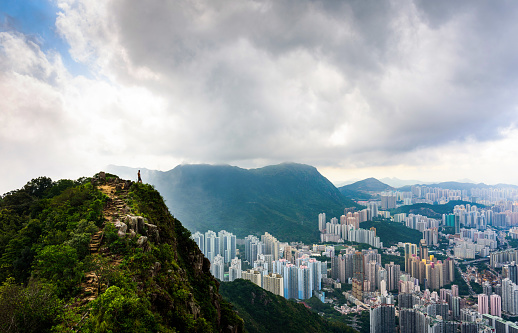 Man enjoying fogy Hong Kong view standing at the Lion rock top