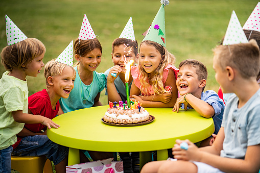 children celebrating birthday in the park and they are happy