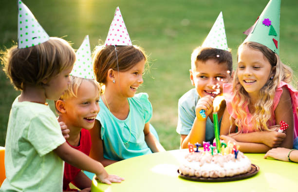 istock blowing birthday candle in the park 1031545986