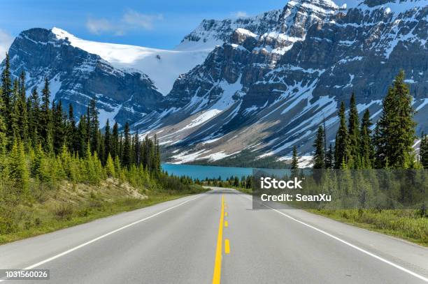 Icefields Parkway At Bow Lake A Spring Evening View Of Icefields Parkway Extending Towards Bow Lake With Bowcrow Peak Crowfoot Glacier And Crowfoot Mountain Rising High Behind Banff National Park Ab Canada Stock Photo - Download Image Now