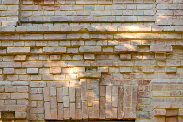 istock Old brick ancient wall background. Decorative abstract background. Rough red old brickwork. Used for conceptual and visual design texture. 1031560674