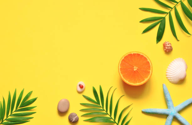 istock Tropical background. Palm trees branches with starfish and seashell on yellow background. Travel. Copy space. 1031560688