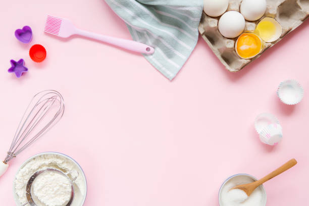 istock Dessert ingredients and utensils on pink pastel background 1031560750