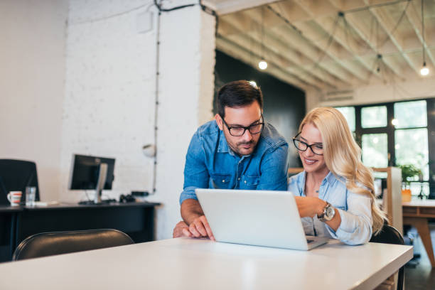 istock Two casual business people working together on a project. 1031563580