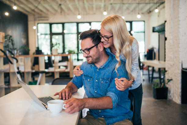 istock Beautiful young couple working in modern office. 1031563640