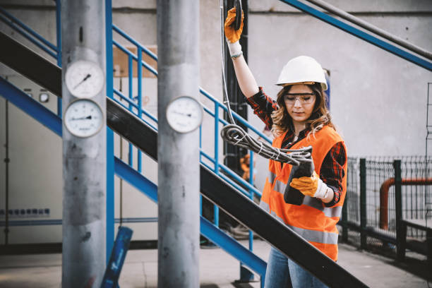 istock Young engineer woman holding and working with remote control for operating crane 1031564290