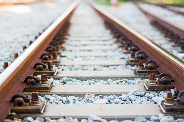 istock Close up rail joint, rail anchor with perspective line from railroad  tracks. Safety transportation. Avoid traffic jam. Public transportation for reduce green house effect. Saving energy and fuel. 1031564362