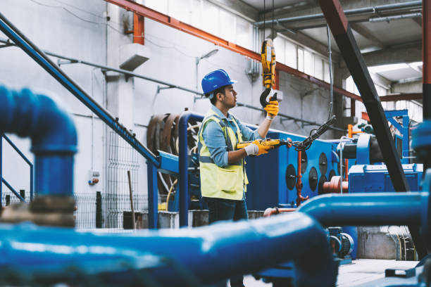 istock Young businessman holding and working with remote control for operating crane 1031566606