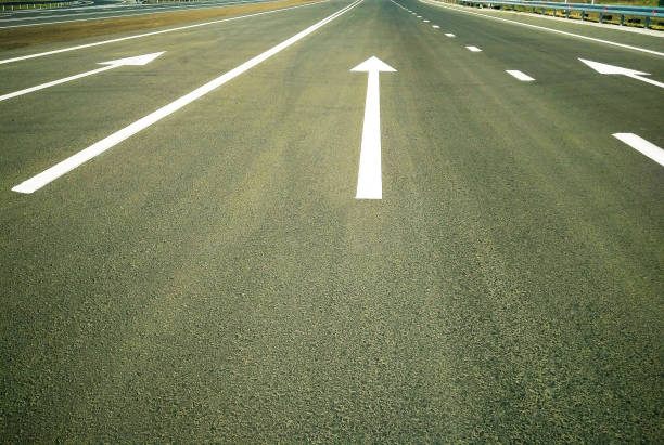 istock Asphalt road with arrow sign. 1031566746