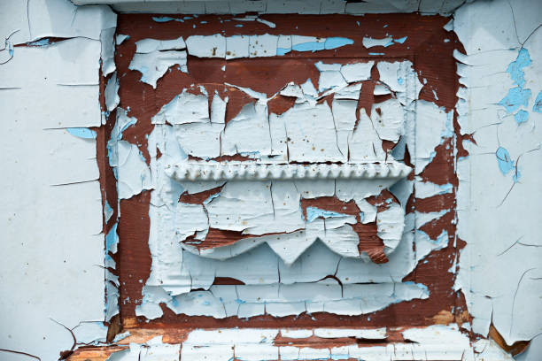 background of aged and weathered textured wooden planks with old paint. Peeling blue paint on a wooden surface as a background