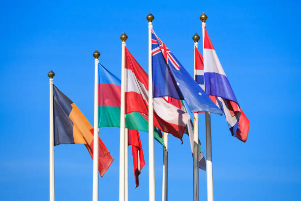 istock Flags of different countries flutters in the wind against a bright blue sky 1031567190