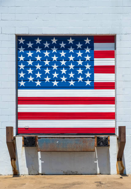 istock The United States of America flag painted on loading/unloading warehouse dock door 1031570310
