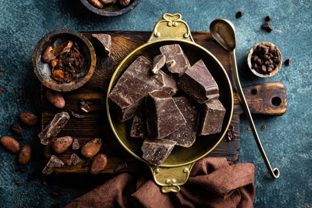 istock Dark chocolate pieces crushed and cocoa beans. Chocolate background 1031570614