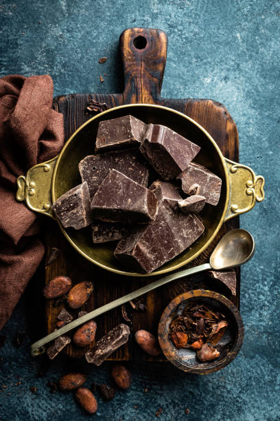 istock Dark chocolate pieces crushed and cocoa beans. Chocolate background 1031570618