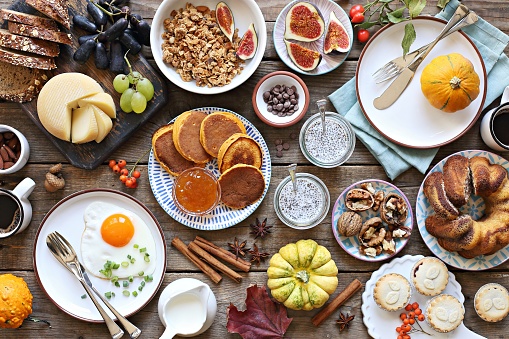 Brunch. Thanksgiving family breakfast or brunch set served on rustic wooden table. Overhead view, copy space
