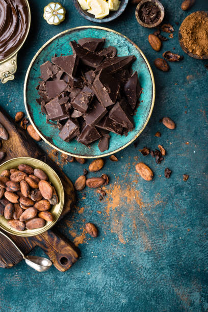 istock Chocolate. Dark bitter chocolate chunks, cacao butter, cocoa powder and cocoa beans. Chocolate background 1031584030
