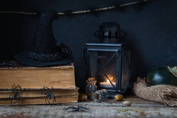 istock Halloween holiday background with lantern, spiders, old books, black witchhat 1031584088