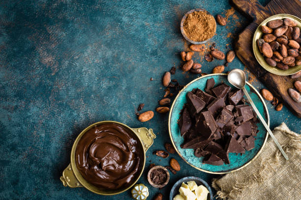 istock Chocolate. Dark bitter chocolate chunks, cacao butter, cocoa powder and cocoa beans. Chocolate background 1031584110