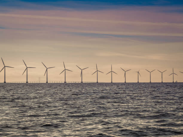 istock Wind turbines power generator farm along coast sea 1031592356