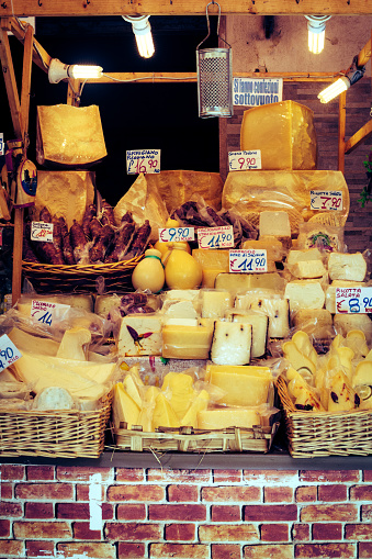 Large selection of cheeses on a market stall in Catania, Sicily