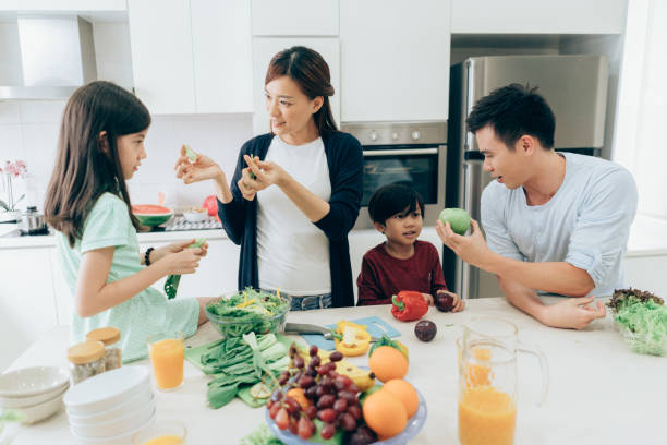 istock Cheerful family preparing lunch together 1031593550