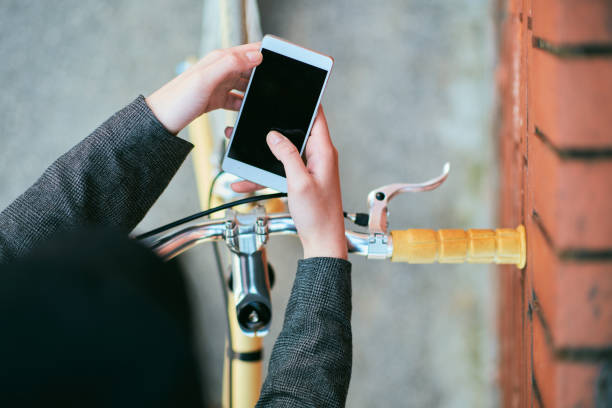 istock Girl sitting on the bicycle and using smart phone. 1031597276