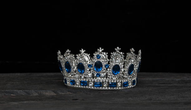 istock silver royal crown on a black wooden background 1031603322