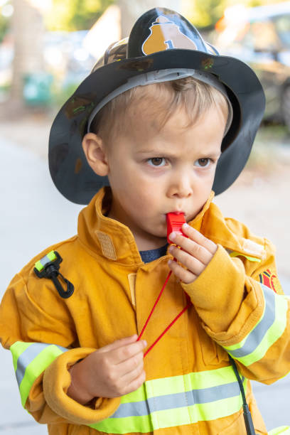 istock toddler posing wearing a firefighter costume 1031603618