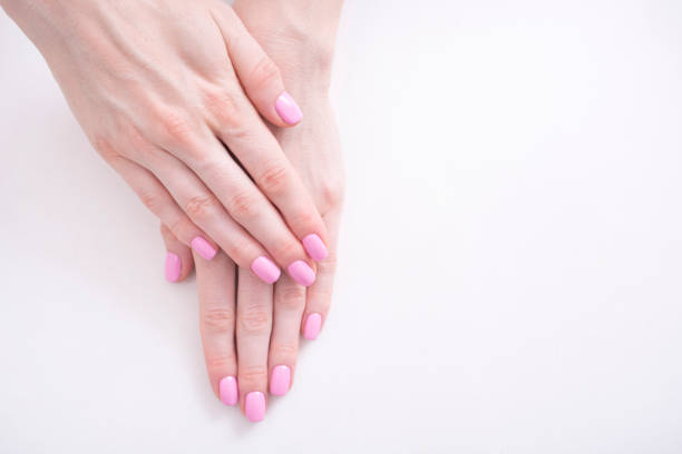 istock Gentle pink manicure. Female hands on a white background 1031606514