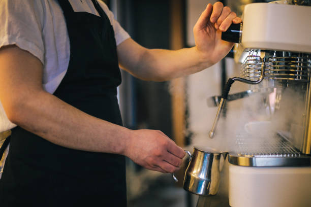 istock Barista making a cup of coffee in machine 1031617570