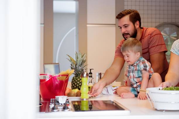 istock Men prepares the meal with his Down's Syndrome nephew 1031617784