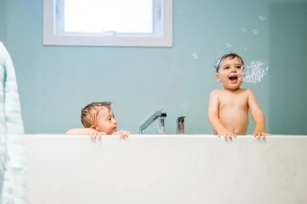 Photo of Down's Syndrome sweet boy in the bath with his brother