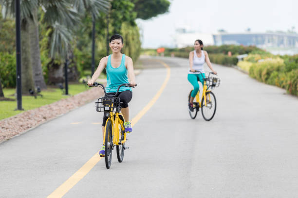 istock Two women enjoy touring Singapore on bicycles 1031621042