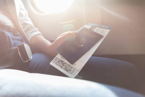 istock Woman holds boarding pass and passport 1031623226